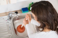 Woman Using Plunger In Sink stock images Woman Using Plunger In Sink stock images