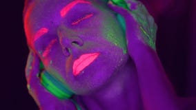 Woman with UV fluorescent makeup