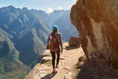 Woman walk on narrow mountain path stock photos Woman walk on narrow mountain path stock photos