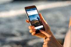 Woman Watching Instagram News With New IPhone Stock Photos Woman Watching Instagram News With New IPhone Stock Photos