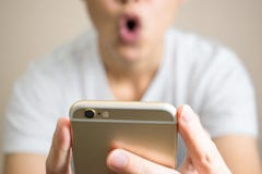 A woman wear white t-shirts very shocked. After receiving a message from the phone royalty free stock photography A woman wear white t-shirts very shocked. After receiving a message from the phone royalty free stock photography