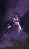 Woman Wearing Purple Bikini Riding on Sports Motorcycle With Smoke Royalty Free Stock Image Woman Wearing Purple Bikini Riding on Sports Motorcycle With Smoke Royalty Free Stock Image