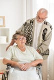 Senior woman on wheelchair with elderly friend behind her stock images Senior woman on wheelchair with elderly friend behind her stock images