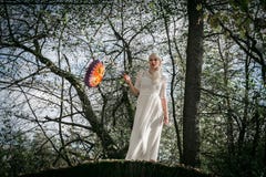 Woman with white dress and a lantern in a forest royalty free stock photo Woman with white dress and a lantern in a forest royalty free stock photo