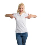 Woman in white polo T-shirt pointing at it with both hands stock photo Woman in white polo T-shirt pointing at it with both hands stock photo