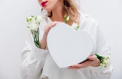Woman with white roses holding a heart shape gift box. stock image Woman with white roses holding a heart shape gift box. stock image