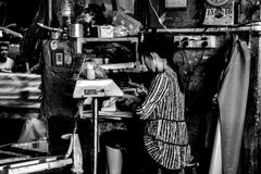 Woman who is in old roadside computing in Liwan District, Guangzhou,China royalty free stock photos Woman who is in old roadside computing in Liwan District, Guangzhou,China royalty free stock photos