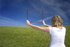 Woman With Frame On Big Meadow Stock Image