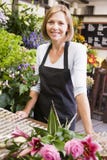 Woman working at flower shop smiling