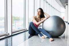 Woman Working Out With Exercise Ball In Gym. Pilates Woman Doing Exercises In The Gym Workout Room With Fitness Ball. Fitness Woma Stock Photo Woman Working Out With Exercise Ball In Gym. Pilates Woman Doing Exercises In The Gym Workout Room With Fitness Ball. Fitness Woma Stock Photo