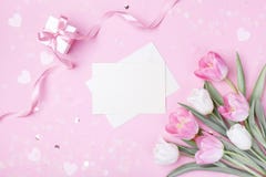 Women Day, Mother day background with envelope, gift box and beautiful spring tulip flowers on pastel pink desk. Flat lay royalty free stock image Women Day, Mother day background with envelope, gift box and beautiful spring tulip flowers on pastel pink desk. Flat lay royalty free stock image