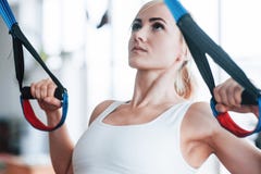 Women doing push ups training arms with trx fitness straps in the gym Concept workout healthy lifestyle sport stock photos Women doing push ups training arms with trx fitness straps in the gym Concept workout healthy lifestyle sport stock photos