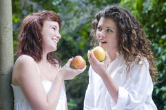 Women Eating An Apple And Laughing Stock Images