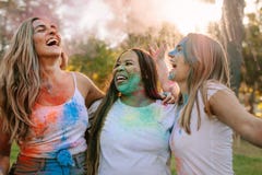 Women friends playing holi in a park royalty free stock photography Women friends playing holi in a park royalty free stock photography