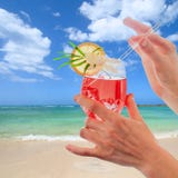 Women Hands Holding A Colorful Cocktail On A Tropical Beach. Stock Image