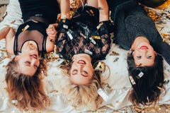 Women hangout joy lying upside down confetti stock photo Women hangout joy lying upside down confetti stock photo