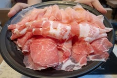 Women holding a slice of pork ready to eat stock images Women holding a slice of pork ready to eat stock images