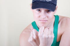 Women In A Cap Shows Fists Royalty Free Stock Images