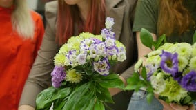 Women learn to make floral design under the guidance of a professional. A group of young women in the class of stock video Women learn to make floral design under the guidance of a professional. A group of young women in the class of stock video