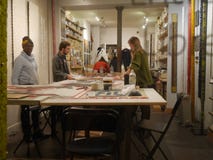 Women and men are at the table and doing business. France, Paris, Montmartre, rue Bochart de Saron. 20.10.2018 stock photo Women and men are at the table and doing business. France, Paris, Montmartre, rue Bochart de Saron. 20.10.2018 stock photo
