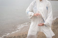 Women practicing Taijiquan on the beach Stock Photography