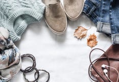 Women`s autumn clothing set - jeans, suede sneakers, pullover, scarf and leather bag. Women`s clothes for autumn walks on a ligh Stock Photography Women`s autumn clothing set - jeans, suede sneakers, pullover, scarf and leather bag. Women`s clothes for autumn walks on a ligh Stock Photography