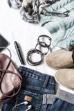 Women`s autumn clothing set - jeans, suede sneakers, pullover, scarf and leather bag. Women`s clothes for autumn walks on a ligh Royalty Free Stock Photography Women`s autumn clothing set - jeans, suede sneakers, pullover, scarf and leather bag. Women`s clothes for autumn walks on a ligh Royalty Free Stock Photography