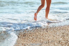 Women`s beautiful legs on the beach stock photos Women`s beautiful legs on the beach stock photos