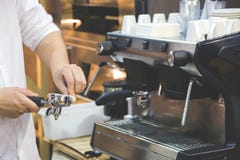 Women`s hands clean holder for coffee machine stock photography Women`s hands clean holder for coffee machine stock photography