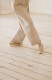 Women`s legs in beige trousers. Dancing, delicate photography. stock image Women`s legs in beige trousers. Dancing, delicate photography. stock image