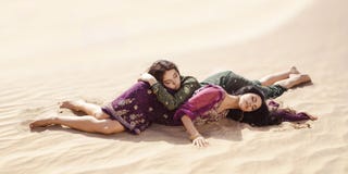 Women thirsty laying in a desert. Lost in desert durind sandshtorm stock photo Women thirsty laying in a desert. Lost in desert durind sandshtorm stock photo
