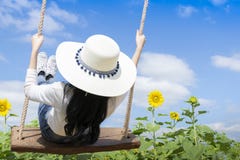 Women Tourists Are Enjoying The Beautiful Nature, Are Playing Wooden Swings Stock Photo