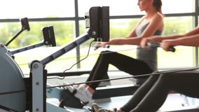 Women working out on rowing machine