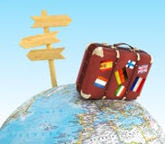 Wood sign board and old suitcase with striples flags on blurred world map stock photography Wood sign board and old suitcase with striples flags on blurred world map stock photography