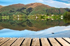 Wood Texture and Beautiful Summer Landscape Background with Green Trees, Mountains and Mirror Lake Reflection