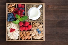 Wooden Box With Breakfast Items - Oatmeal, Granola, Nuts, Berry Royalty Free Stock Images