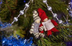 Wooden boy and girl figurines on the Christmas tree branch. Christmas decor. royalty free stock image Wooden boy and girl figurines on the Christmas tree branch. Christmas decor. royalty free stock image