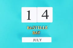 wooden calendar on a blue background. The concept of the holiday is July 14, the Day of the Bastille. Royalty Free Stock Photos wooden calendar on a blue background. The concept of the holiday is July 14, the Day of the Bastille. Royalty Free Stock Photos