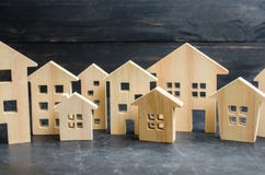 Wooden City And Houses. Concept Of Rising Prices For Housing Or Rent. Growing Demand For Housing And Real Estate. Stock Photo