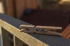 Wooden clothespin on a railing