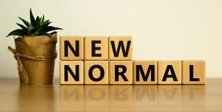 Wooden cubes with words `new normal`. The world is changing to balance it into new normal include business , economy , environme