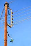 Wooden electric pillar with wires in a blue sky background. stock photos Wooden electric pillar with wires in a blue sky background. stock photos