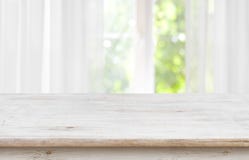 Wooden empty board in front of blurred curtained window background Royalty Free Stock Photo Wooden empty board in front of blurred curtained window background Royalty Free Stock Photo