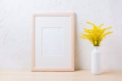 Wooden frame mockup with ornamental yellow flowering grass in va stock images Wooden frame mockup with ornamental yellow flowering grass in va stock images