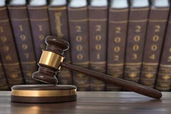 Wooden gavel and law books in lawyers office stock illustration Wooden gavel and law books in lawyers office stock illustration
