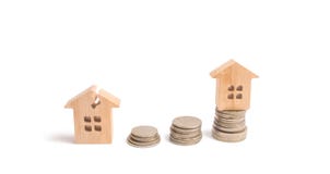 Wooden houses on the stacks of coins. Investing in the repair and restoration of housing. Overhaul. raising money stock image Wooden houses on the stacks of coins. Investing in the repair and restoration of housing. Overhaul. raising money stock image