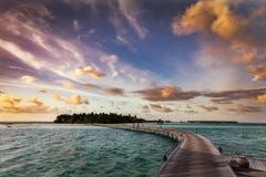 Wooden jetty towards a small island in Maldives at sunset stock image Wooden jetty towards a small island in Maldives at sunset stock image