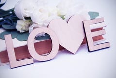 Wooden love letters inscription with heart shape. Vintage style with white flowers. Toned. royalty free stock images Wooden love letters inscription with heart shape. Vintage style with white flowers. Toned. royalty free stock images