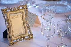Wooden picture frame with copy space positioned on a table prepared for a special event stock photography Wooden picture frame with copy space positioned on a table prepared for a special event stock photography