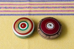 Wooden retro yoyos on yellow tablecloth. Traditional mexican toys Wooden retro yoyos on yellow tablecloth. Traditional mexican toys